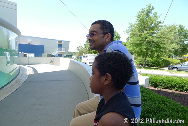 Hubby and son looking at the seals in the tank in front of the Virginia Aquarium