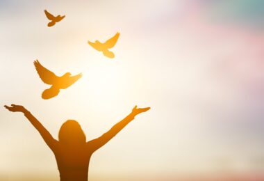 woman opening her arms up in prayer
