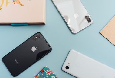 photo of four iphones on blue surface
