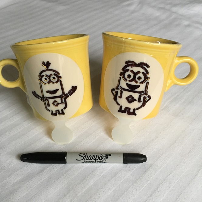 Minions stencils taped onto the mug 